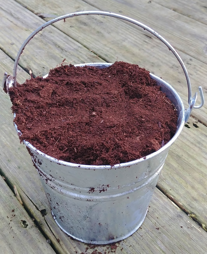 galvanized bucket of peat moss